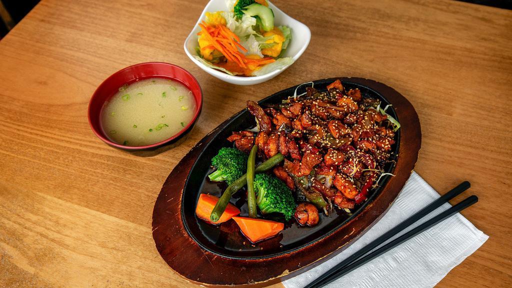 Spicy Chicken · Hot. Stir fried chicken, onion, red, and green pepper, steamed vegetables and sesame seeds with sweet hot sauce. Served with mio salad.