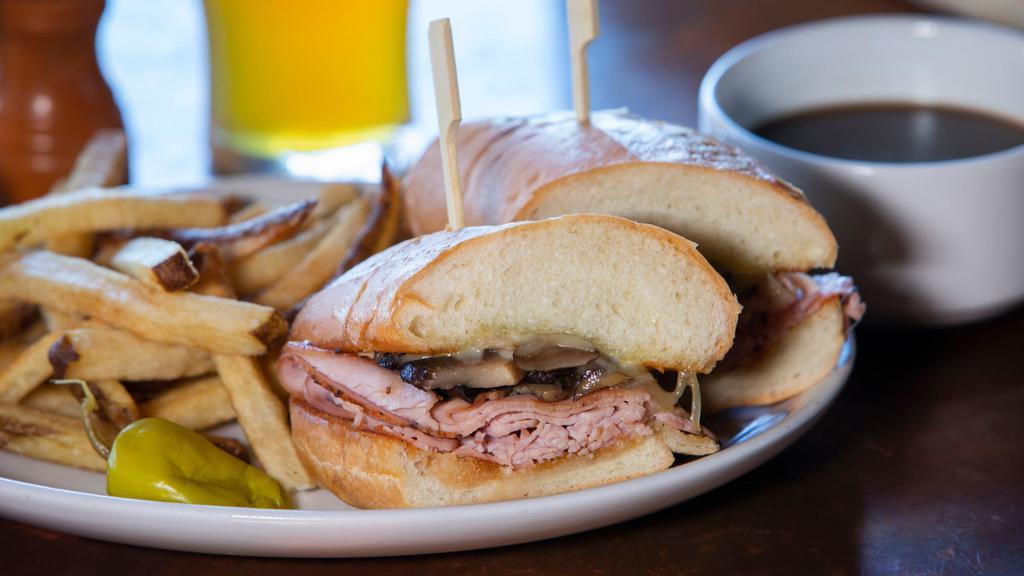 Portland Dip · Turkey, grilled mushrooms, Swiss cheese & secret sauce on a roll with garlic jus for dipping.