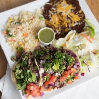 Taco Combo · Three tacos with a side of rice, beans, and lettuce topped with diced tomatoes.