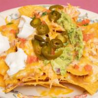 The Original Durango Nachos · Tortilla chips, melted jack cheese, tomatoes, onions, jalapeños, beans, guacamole and sour c...