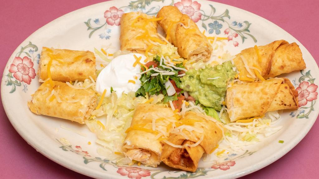 Chicken Taquitos · Two rolled flour tortillas stuffed with chicken flash fried and topped off with pico de gallo, cheese, guacamole and sour cream .
