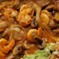 Arroz Con Camarones · Tiger. Shrimps sauteed with onions, mushrooms and served on a bed of rice. Topped with jack ...
