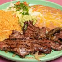 Carne Asada · A generous skirt of beef steak, char-broiled and garnished with onions. Served with rice, be...