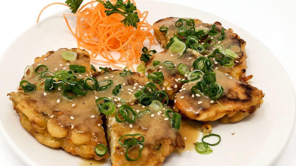 Japanese Pancake (Okonomiyaki) · Wheat flour and egg battered with cabbage, sweet potato, green onion and white onion. Served with our home-made sauce and tops with green onion and sesame seeds.