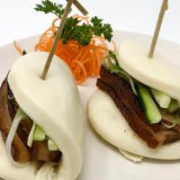 Pork Belly Buns (2 Pcs) · Popular item. Steamed bun stuffed with braised pork belly, scallions, and cucumbers with hoi...