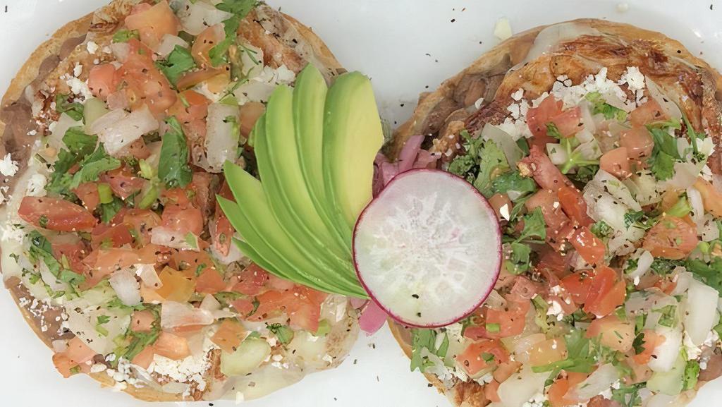 Molletes · Ciabatta bun with spreadable beans and melted cheese + cotija cheese, pico de gallo, pickled red onion, radish & avocado. 
Add your favorite stew +$6