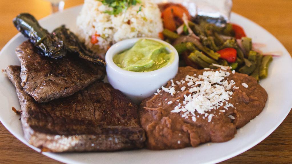 Asada Plate · Thinly sliced flank steak, pork chorizo, rice, beans, guacamole, cactus salad and heirloom corn tortillas.