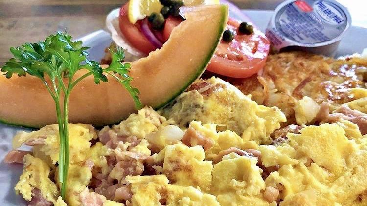 The Leo · Scrambled lox, eggs & onions, served w/ a bagel, sliced onions, tomatoes, capers & hash browns.