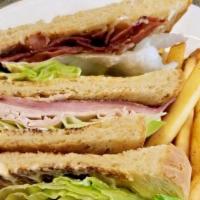 Club House Sandwich · Triple decker w/ turkey, ham, bacon, tomato, lettuce & mayo, on toasted sour dough.