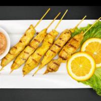 Chicken Satay (5) · Tender grilled chicken marinated in thai satay spice and coconut milk. Served with peanut sa...