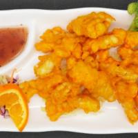 Golden Squid · Calamari dipped in tempura batter and lightly fried until golden brown. Served with sweet an...