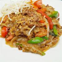 Pad Drunken Noodles · Mildly spicy. Stir fried flat noodles with egg, bell pepper, sweet basil leaf, tomato and on...