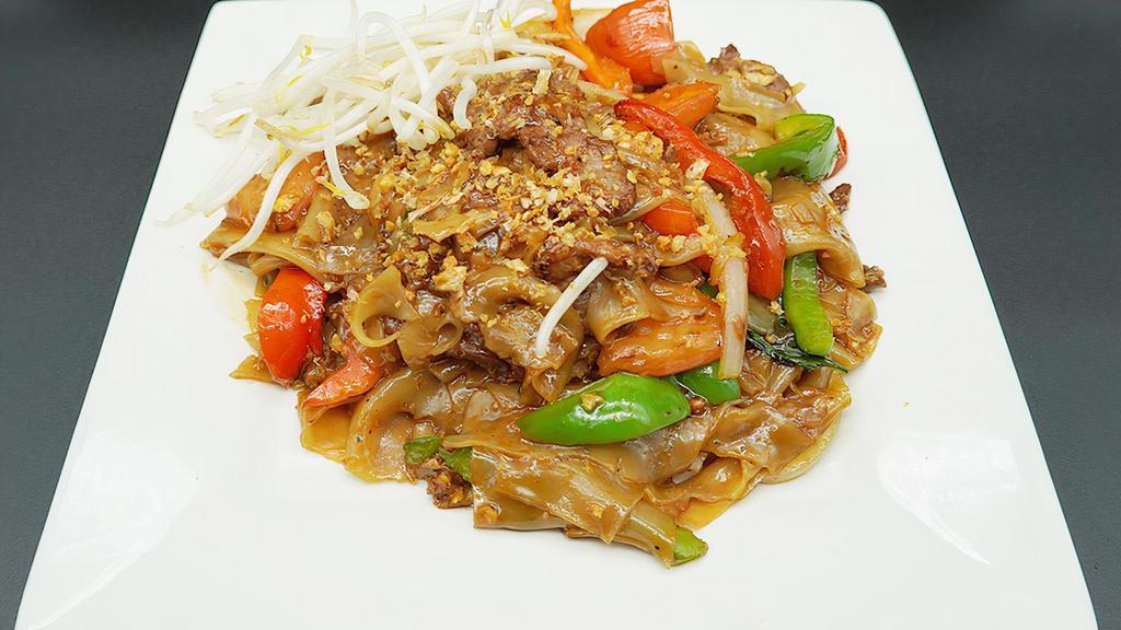Pad Drunken Noodles · Mildly spicy. Stir fried flat noodles with egg, bell pepper, sweet basil leaf, tomato and onion. Served with fresh bean sprouts.