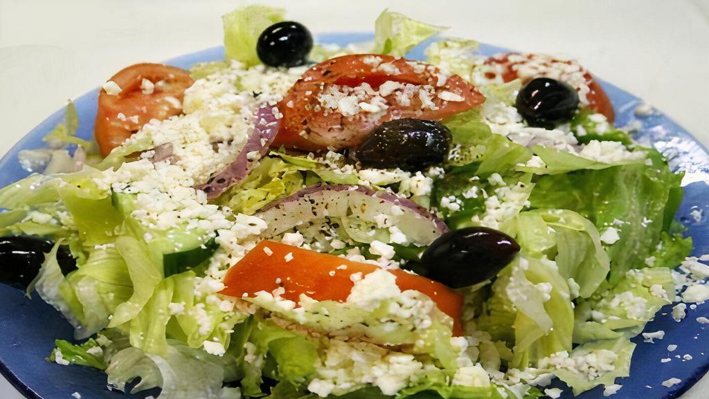 Greek Salad · Fresh lettuce, tomatoes, cucumbers, onions, feta cheese, kalamata olives and Greek dressing served with warm pita