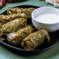 Dolma Plate · 5 Grape leaves stuffed with rice and spices, served with warm sliced pita and a side of tzat...