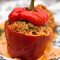 Stuffed Bell Pepper · Large bell pepper stuffed with pork, beef, rice, carrots and spices simmered in tomato sauce