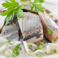 Herring · Pickled herring served with a side of fresh onions and toasted bread