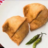 Samosa Singh · Savory deep fried pastry puffs filled with mildly spiced potato and peas.