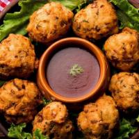 Golden Fried Vegetable · Delicately spiced mix vegetable fried fritters lightly battered chickpea flour served with m...