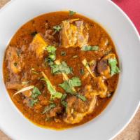 Punjabi Style Mutton Curry(Bone-In) · A traditional brown curry prepared with tomatoes, onions and fresh herbs.