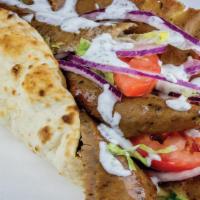 Gyro Wrap · Most popular. Thinly sliced gyro meat piled high on pita bread with lettuce, tomatoes, red o...