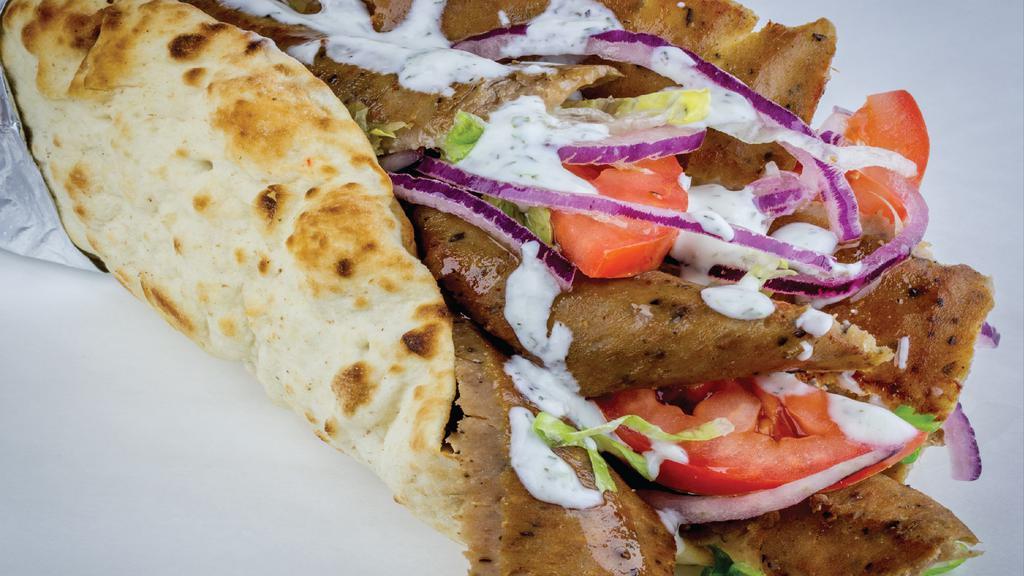 Gyro Wrap · Most popular. Thinly sliced gyro meat piled high on pita bread with lettuce, tomatoes, red onions, and tzatziki sauce. Topped with Feta cheese.