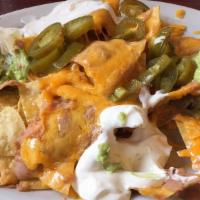 Nachos · Crispy warm tortilla chips topped with melted cheese and diced jalapeños.