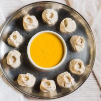Chicken Momo · Steamed chicken dumpling mildly spiced with ginger, garlic, onion and spices.