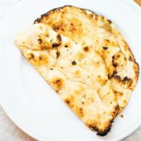 Butter Naan · Indian bread made of white flour, roasted in traditional grills, and slathered with butter.