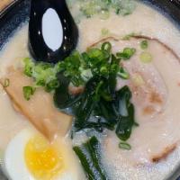 Tonkatsu Ramen · Pork based broth. Topped with chashu pork, corn, green onions, bamboo shoot, egg.