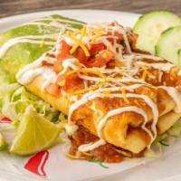 Chimichanga · deep fried burrito with rice, your choice of meat and cheese.
salsa red and green on the top...