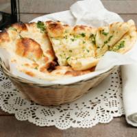 Garlic Naan · Bread layered with fresh garlic and cilantro.