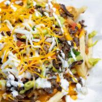 Carne Asada Fries · French Fries topped with Steak, Cheddar Cheese, Guacamole, Sour Cream and Pico de Gallo.