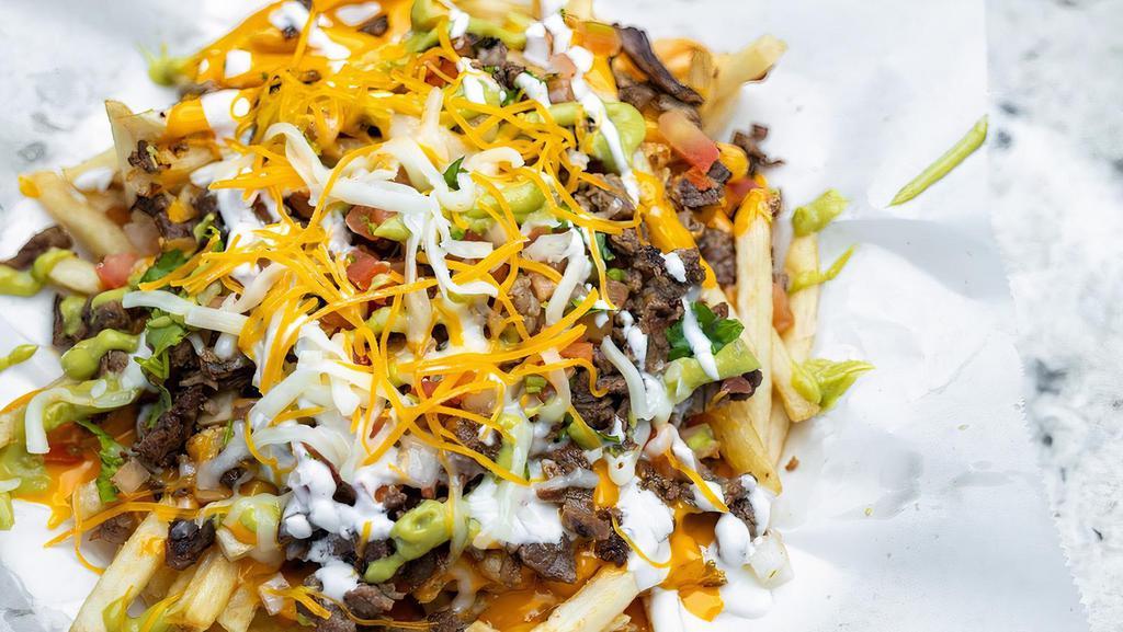 Carne Asada Fries · French Fries topped with Steak, Cheddar Cheese, Guacamole, Sour Cream and Pico de Gallo.