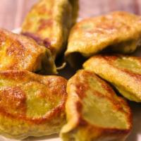 Potstickers (6) · Spice-infused ground pork, Napa cabbage, pan-fried to a golden brown.