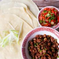Lamb Bao Bing · Spicy. Diced lamb, sichuan mah lah berry, chili. Served with a spicy roasted bell pepper sal...