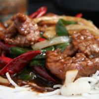 Mongolian Beef · Spicy. Green onion, yellow onions, chili pods, house sauce, served over crispy rice noodles.