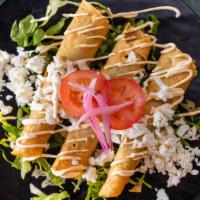 Flautas De Barbacoa /Lamb Barbecue Flautas · Queso fresco, lechuga y crema. / Fresh cheese, lettuce and cream.