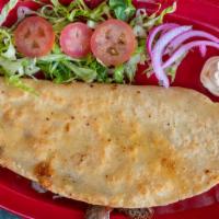 Quesadilla De Maíz · Cooked tortilla that is filled with cheese and folded in half.