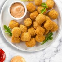 Channing Tater · (Vegetarian) Shredded Idaho potatoes formed into tots, battered, and fried until golden brow...