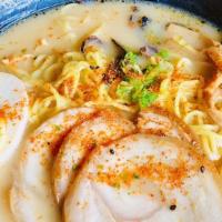 Tonkotsu Ramen · Signature dish. Pork broth, pork belly, half soft-boiled egg, green onions, corn,  bamboo sh...