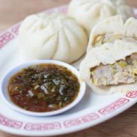 Pork & Cabbage Baozi · Three steamed buns filled with pork and cabbage seasoned with ginger, garlic and soy sauce.