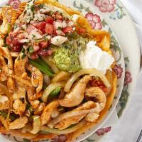 Taco Salad · Crispy flour tortilla shell fresh chopped lettuce topped with choice of meat, shredded chees...