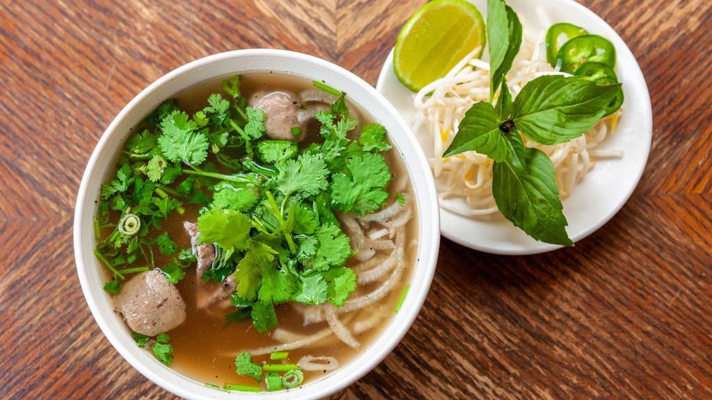 Pho - Beef (Gf) · Eye round, brisket, and beef meatballs in Grandma's beef pho broth, with rice noodles, onions, and cilantro. Served with a side of lime, jalapeños, bean sprouts and Thai basil.