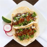 Carne Asada Tacos · Two steak tacos. Topped with cilantro, onion, and salsa.