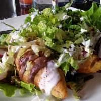 Taquitos Dorados · Three corn tortillas filled with chicken or beef rolled and deep fried. Topped with guacamol...