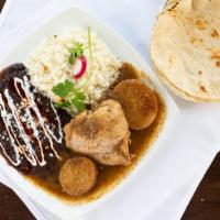 Pollo En Tomatillo · Chicken thigh bathed in a tomatillo sauce. Served with rice, beans and tortillas.