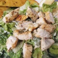 Chicken Caesar Salad · Crisp romaine greens, topped with sliced chicken breast, croutons, parmesan cheese and our o...