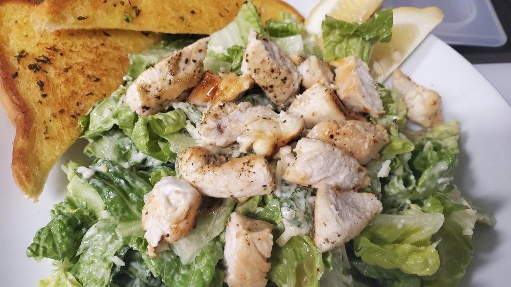 Chicken Caesar Salad · Crisp romaine greens, topped with sliced chicken breast, croutons, parmesan cheese and our own Caesar dressing.