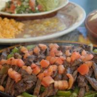 Fajitas · Steak marinated in our secret sauce then sautéed with green onions and bell peppers. Served ...